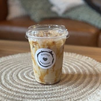 Iced latte with caramel drizzle down the sides of the cup
