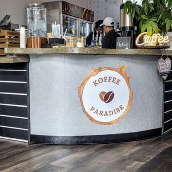 Koffee Paradise order counter with the coffee logo and pickup sign
