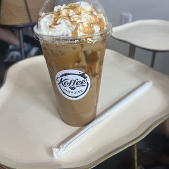 Iced caramel latte topped with whipped cream and caramel drizzle